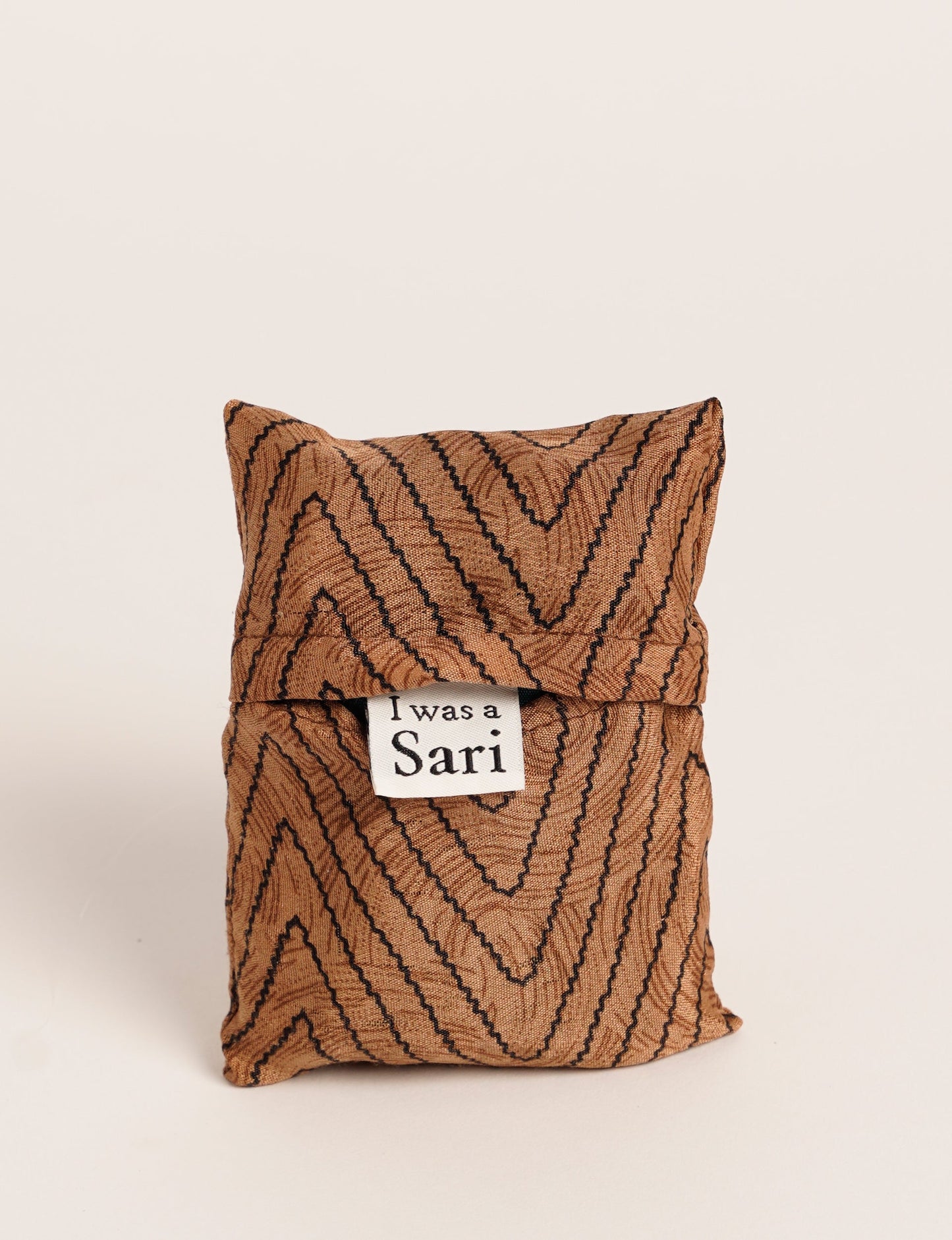 Stay eco-conscious with our Reusable Bag, handmade by Indian artisans from pre-loved saris. Silky and lightweight, this foldaway bag is perfect for your on-the-go lifestyle. Each piece is a unique statement of ethical fashion, embracing sustainability and style.