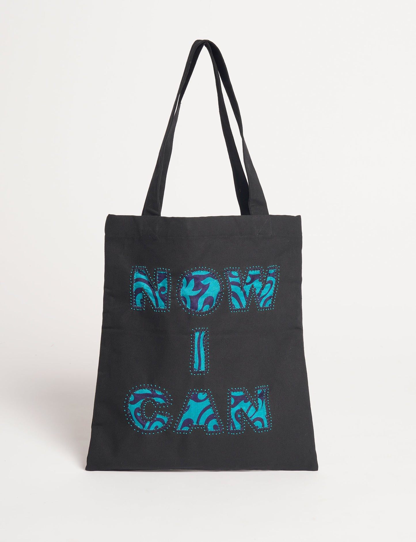 Discover empowerment with our NOW I CAN TOTE BAG – a distinctive piece from our embroidery collection, commemorating positive transformations in the lives of our women artisans. Each bag signifies empowerment, from community pride to supporting education dreams. Carefully crafted with embroidered signatures, these bags are not only visually appealing but also embody the artisans' journeys and the reincarnation of pre-loved saris into a new form – as your treasured bag.