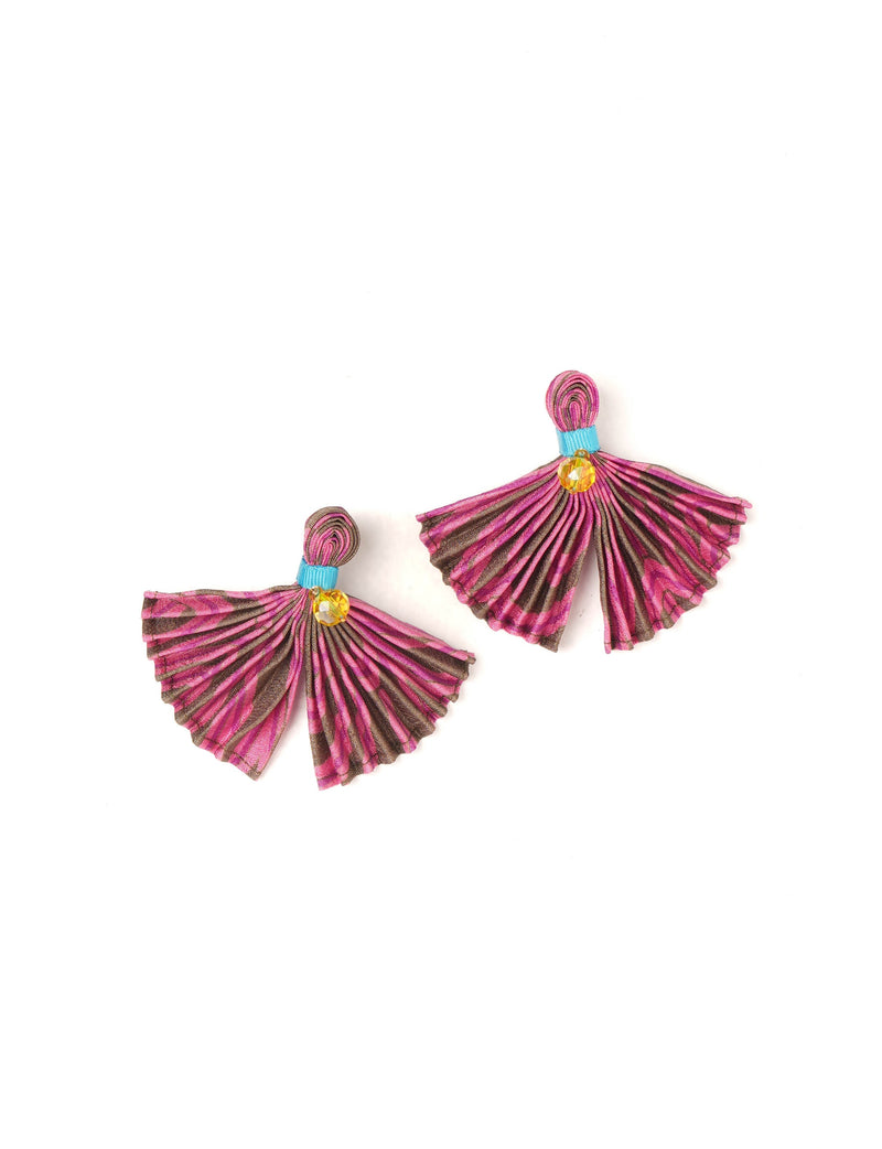 Pink and brown pleated fabric earrings with blue band and yellow bead detail, flat lay on white background