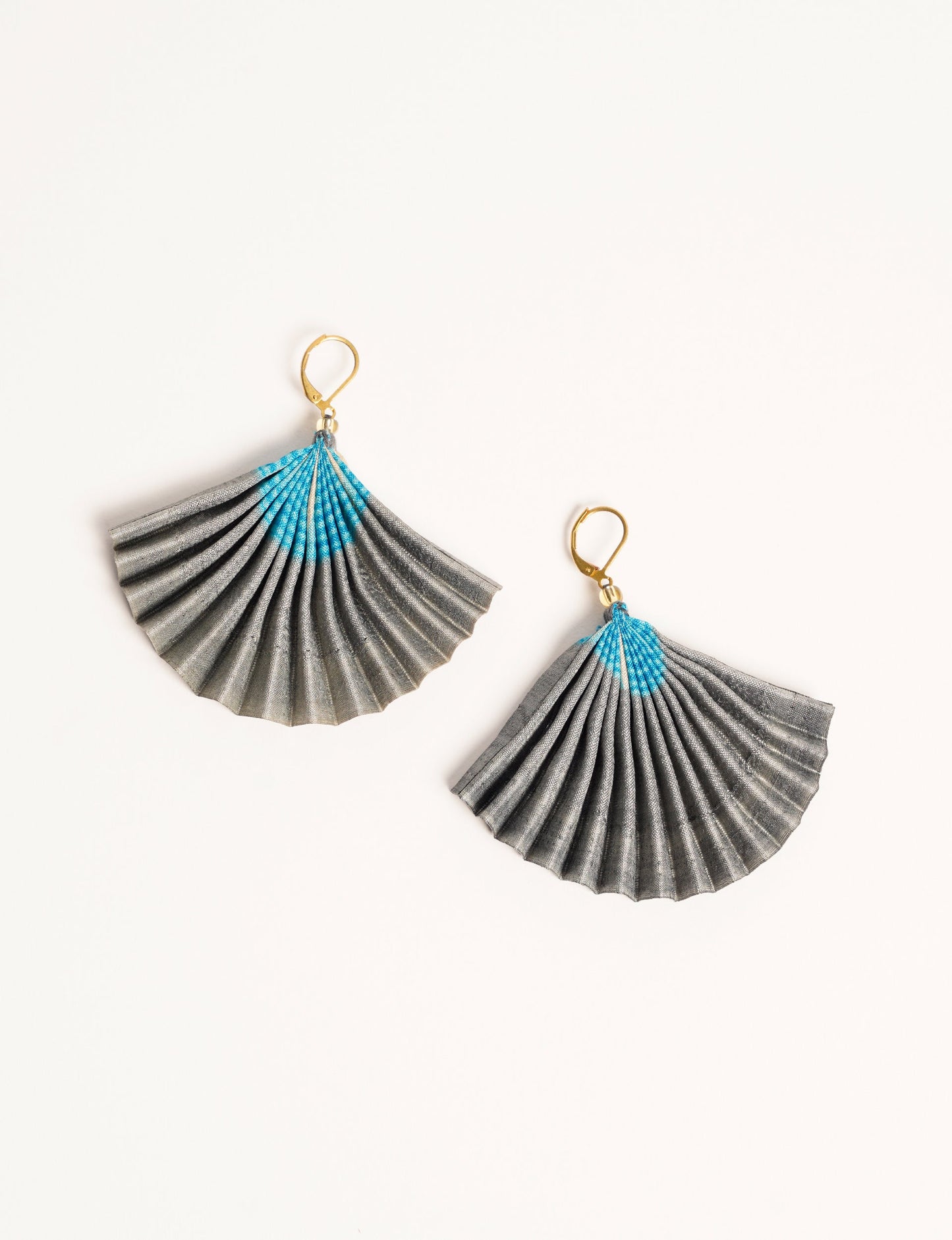 Elevate your style sustainably with our PLEATED EARRINGS – a timeless creation from pre-loved Indian saris, crafted using innovative heat setting techniques. Align with ethical clothing, green fashion, and slow fashion, these earrings are a statement of mindful elegance. Hypoallergy tested metal hooks make them a skin-friendly, sustainable choice.